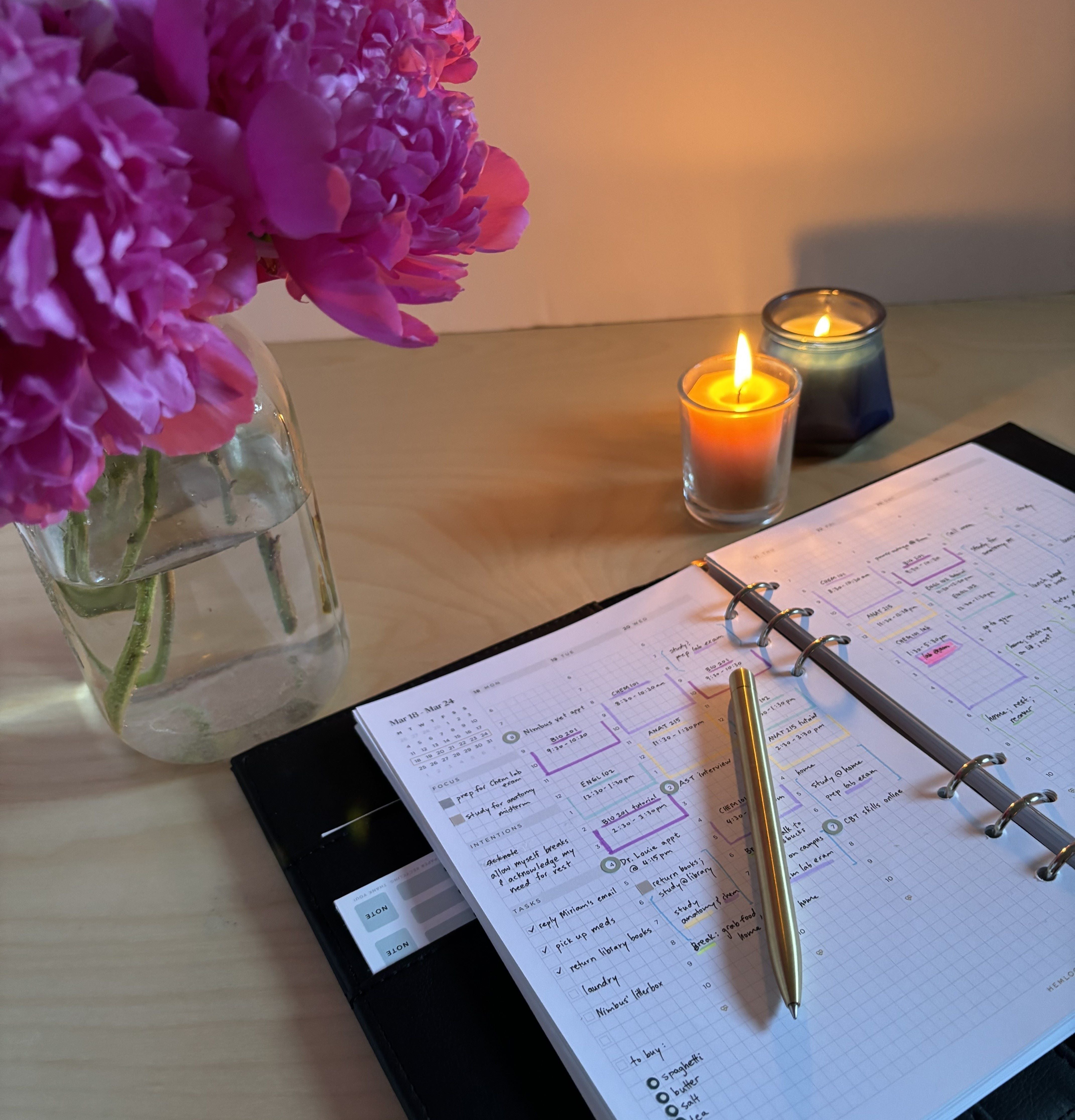 a relaxing planner set up with flowers and candles